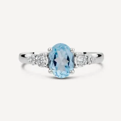 9ct White Gold Oval Blue Topaz Centre 0.14ct Diamond Trefoil Sides Ring