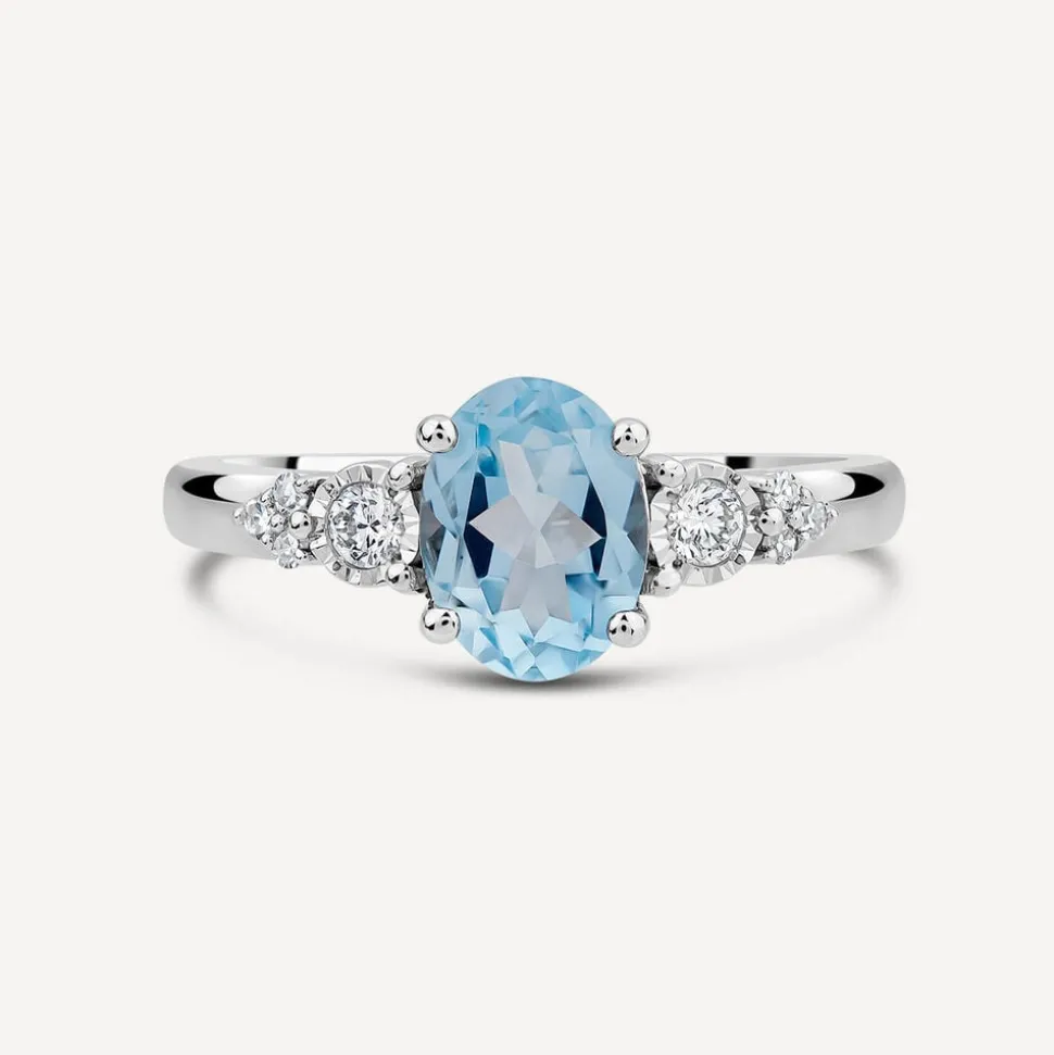 9ct White Gold Oval Blue Topaz Centre 0.14ct Diamond Trefoil Sides Ring