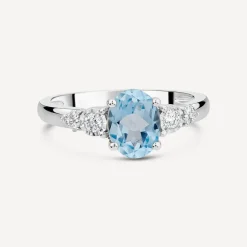 9ct White Gold Oval Blue Topaz Centre 0.14ct Diamond Trefoil Sides Ring